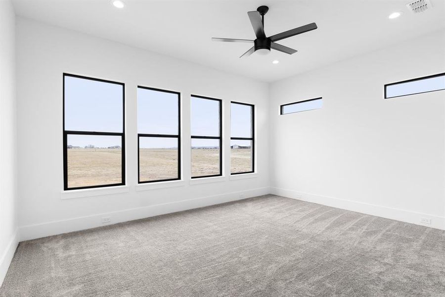 Spare room with carpet floors and ceiling fan