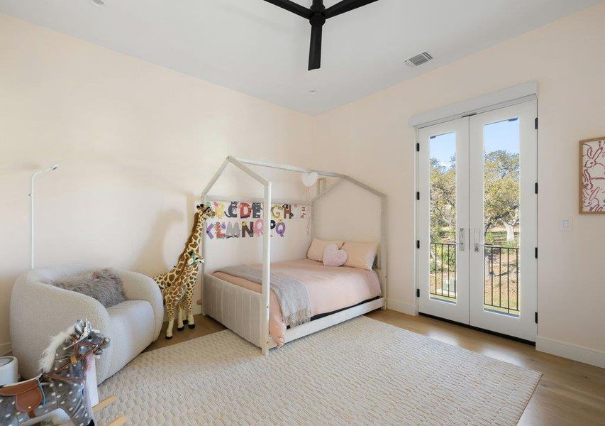Bedroom with french doors, access to exterior, light wood-style floors, and a ceiling fan