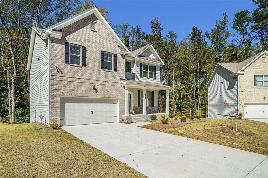 Front exterior of a new home in Paces Estates, Lithia Springs, GA, highlighting curb appeal (Image 2). Front exterior of a new home in Paces Estates, Lithia Springs, GA, highlighting curb appeal (Image 2).