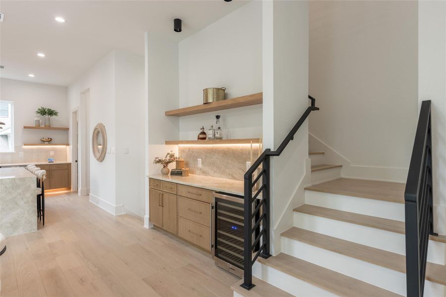 The kind of small moment that elevates the whole floor. A dedicated pour-and-serve station set into the wall at the base of the stair. It's there when you need it, invisible when you don't. Attention to the quiet details is what separates a nice house from a well-made one.