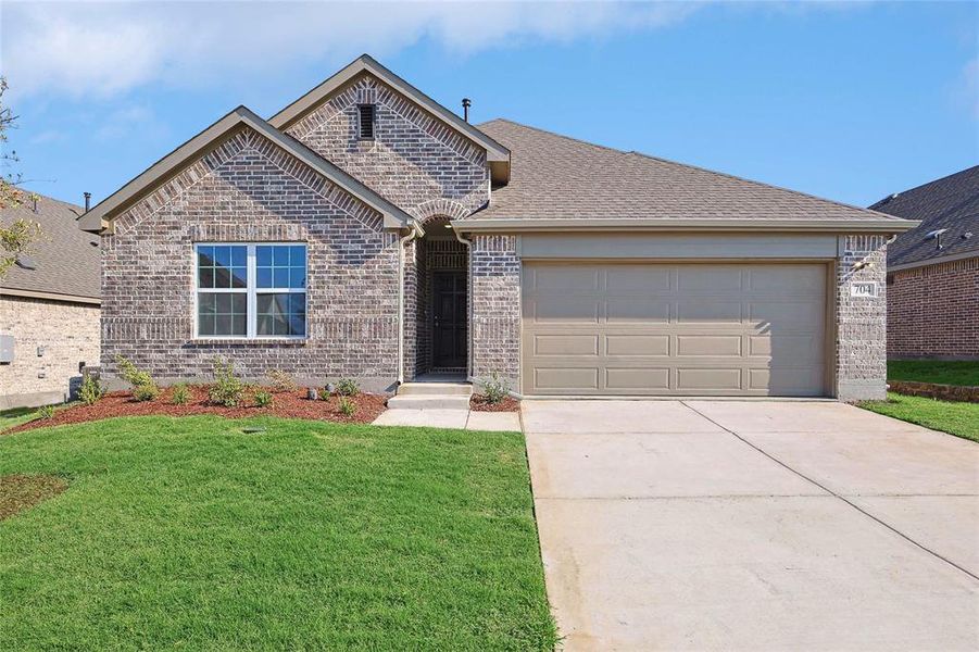 View of front of house featuring a garage and a front lawn