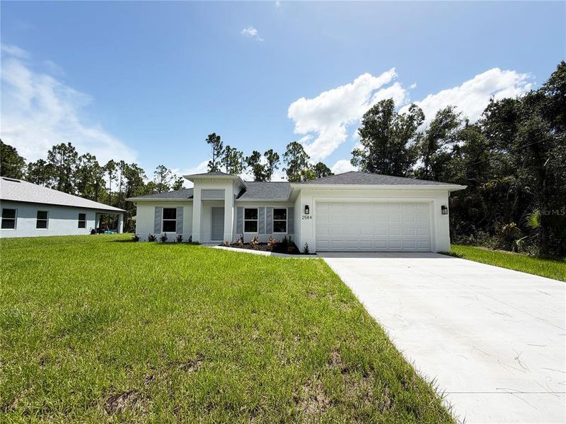 Front exterior of a new home in , North Port, FL, highlighting curb appeal (Image 1). Front exterior of a new home in , North Port, FL, highlighting curb appeal (Image 1).