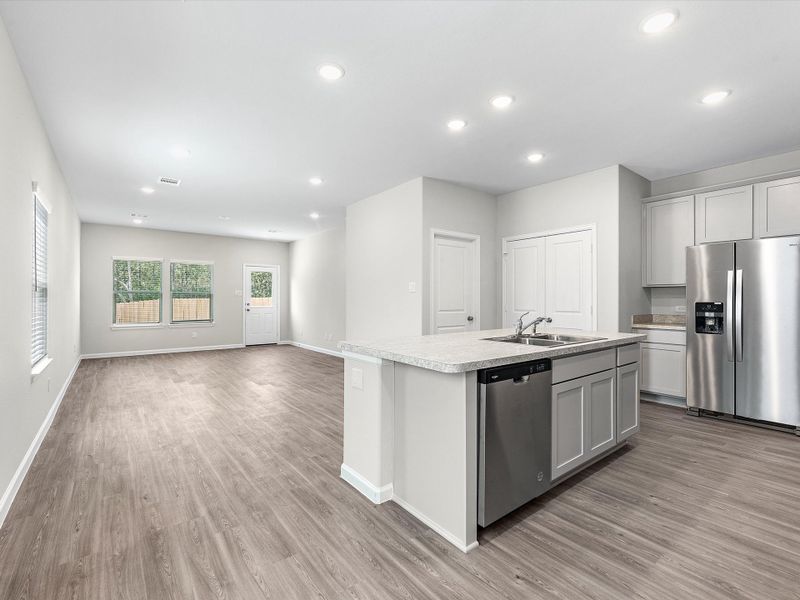 A kitchen with white cabinets.