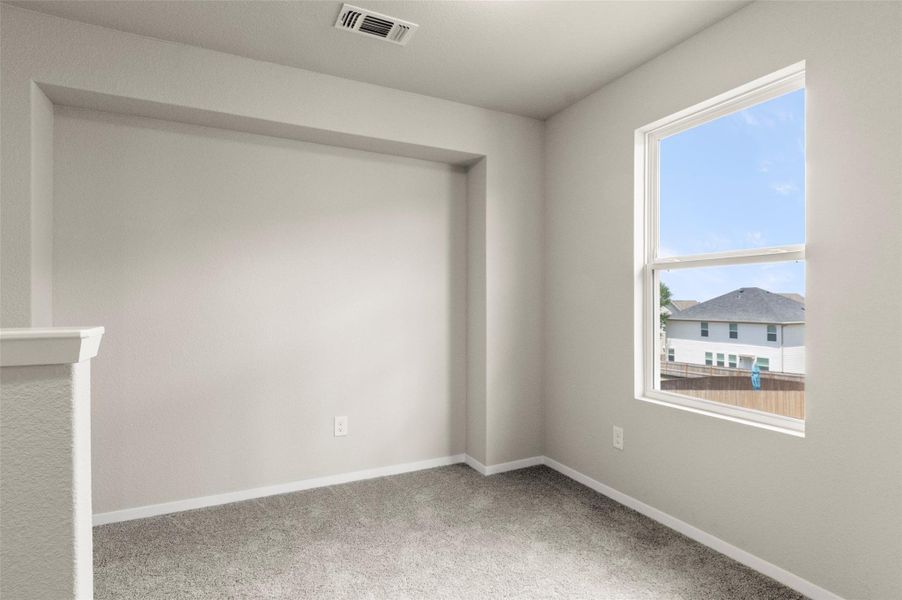 Carpeted spare room with plenty of natural light