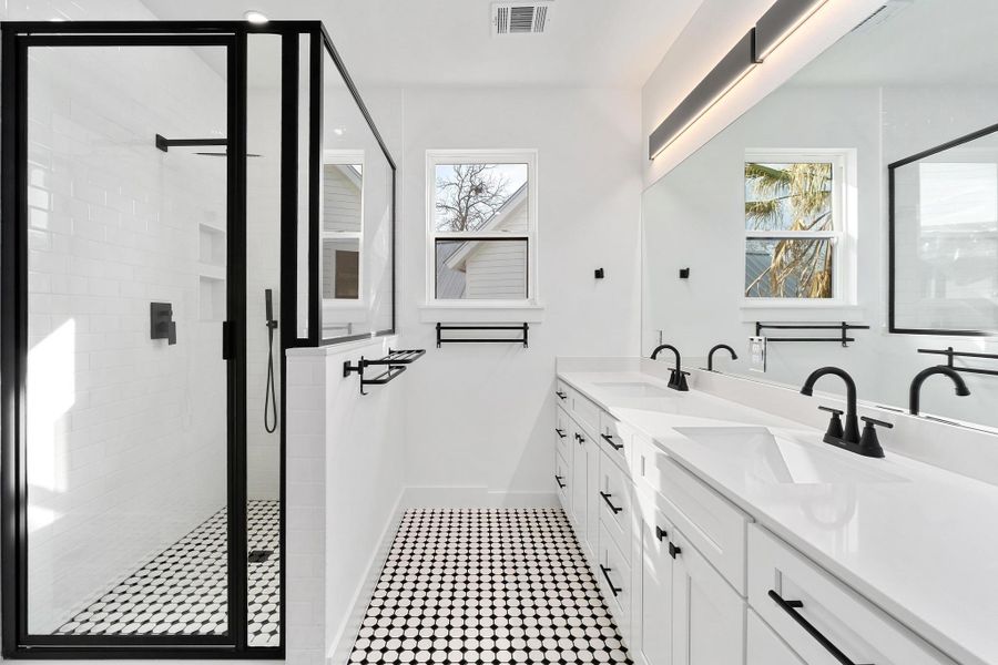 Bathroom with a stall shower and double vanity