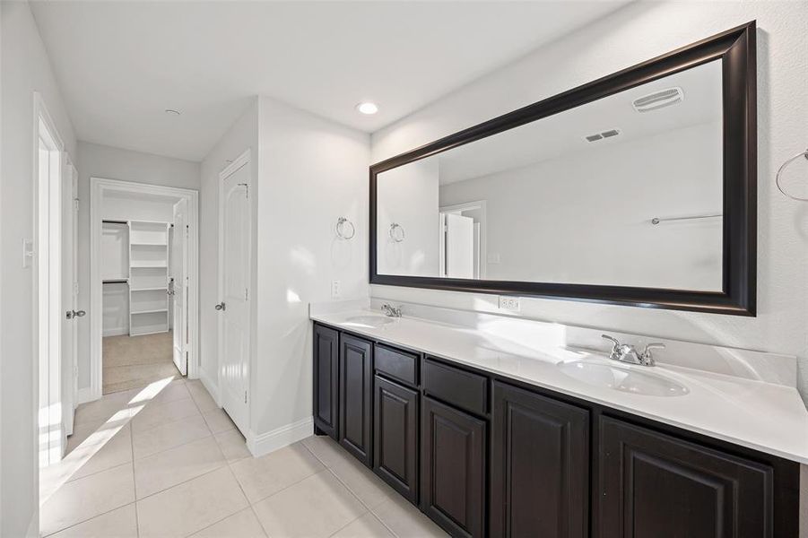 Primary bathroom with double vanities and large shower