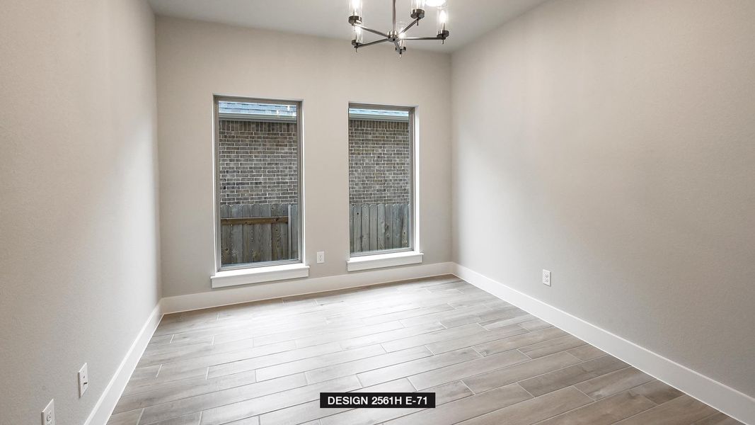 Empty room with a wealth of natural light, an inviting chandelier, and light hardwood / wood-style flooring