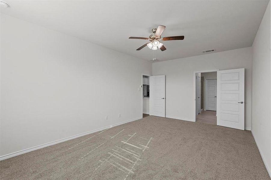 bedroom with ceiling fan and light carpet