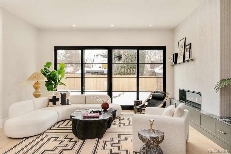 bright living room with a gas fireplace and attractive built-ins