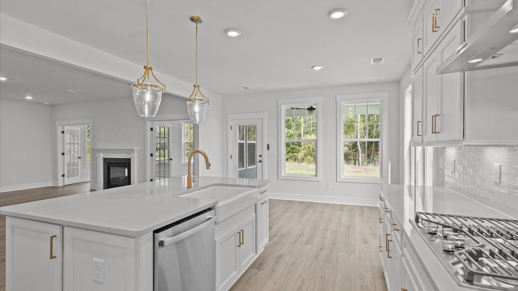 Memorable meals begin in this vibrant kitchen with pendant lighting and a thoughtfully designed island