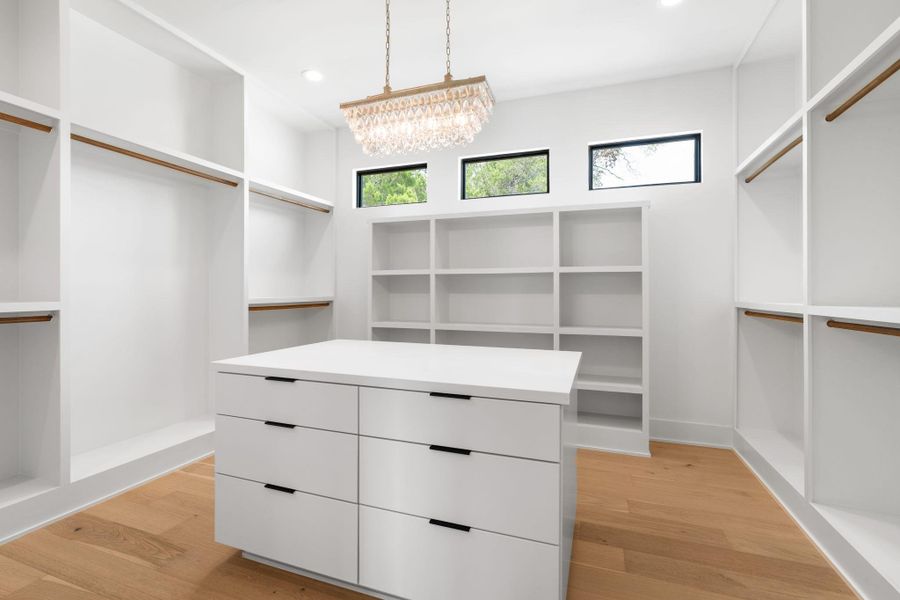 Ample storage solutions and rich hardwood flooring define this well-appointed closet space.