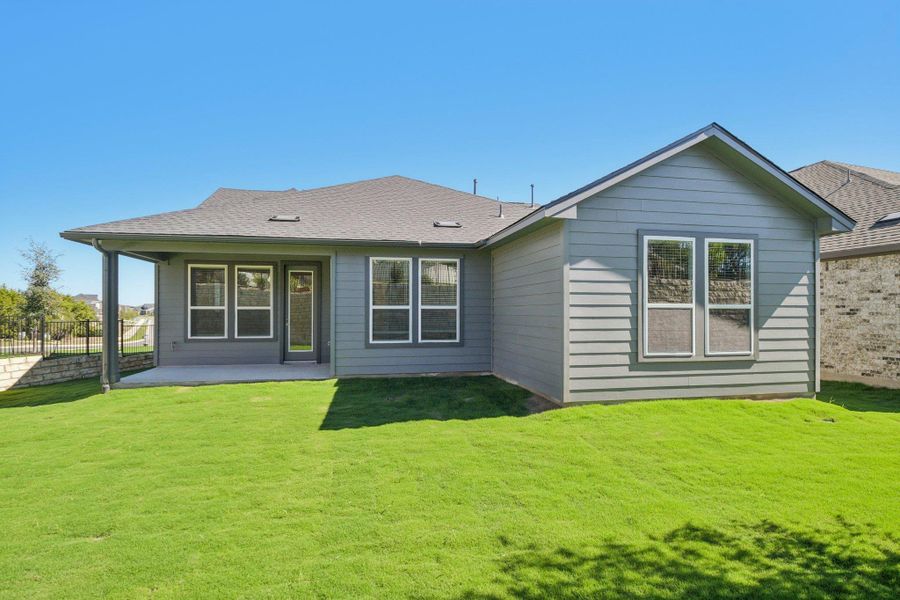 Back of property with a patio area and a shingled roof Back of property with a patio area and a shingled roof