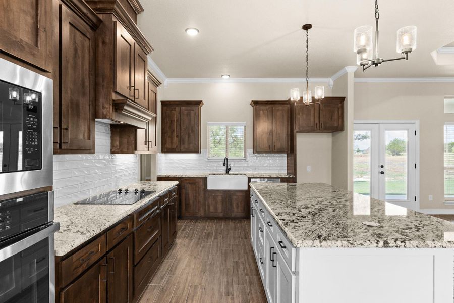 Kitchen with dark brown cabinets, light granite counters, decorative backsplash, stainless steel appliances Kitchen with dark brown cabinets, light granite counters, decorative backsplash, stainless steel appliances