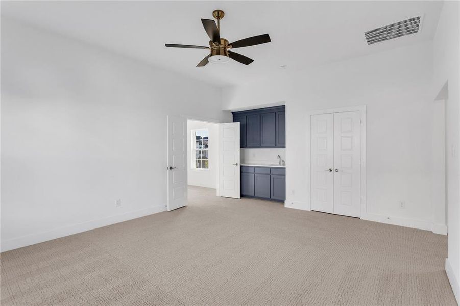 Unfurnished bedroom with light carpet, a closet, and ceiling fan