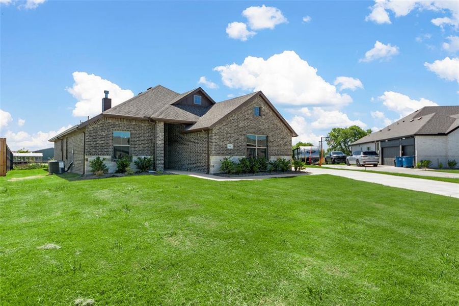 Front exterior of a new home in High Meadows Estates, Nevada, TX, highlighting curb appeal (Image 21).