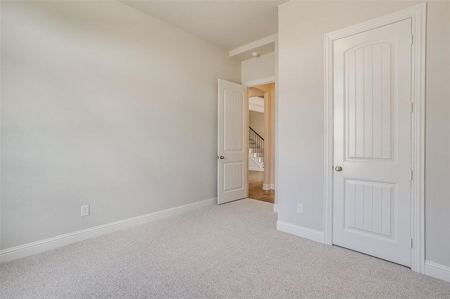 Unfurnished bedroom featuring light colored carpet