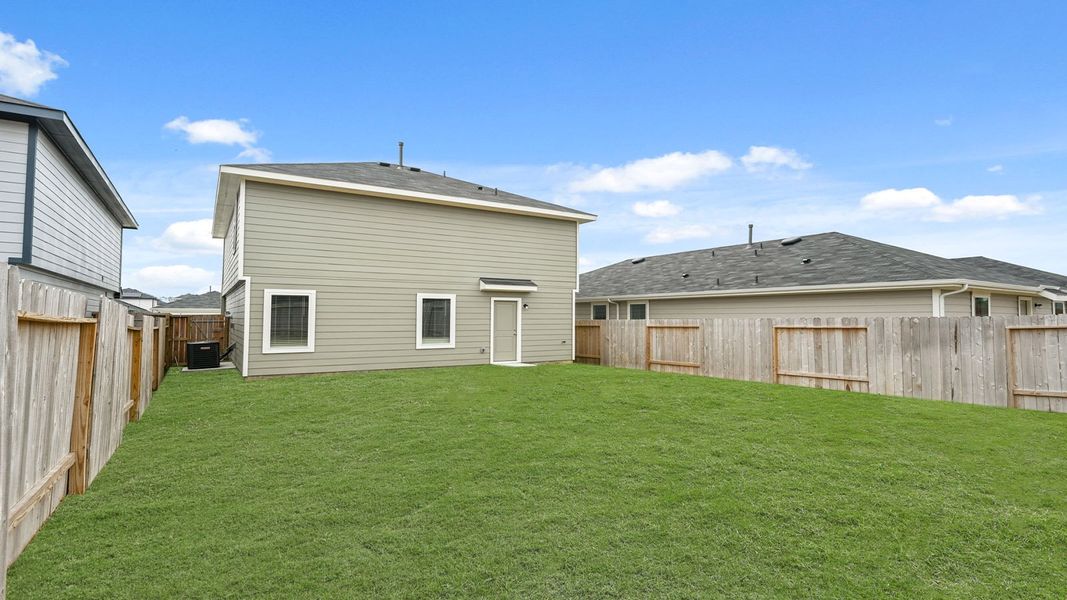 Exterior details and patio area of a home in The Canopies, Splendora (Image 17).
