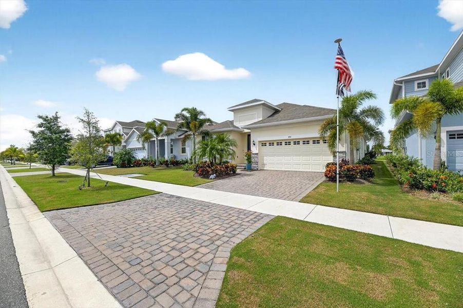 Front exterior of a new home in Marisol Pointe at MiraBay Florida Series, Apollo Beach, FL, highlighting curb appeal (Image 18).