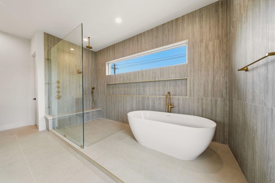 Spa-inspired primary bath offer freestanding soaking tub, oversized shower, and dramatic designer tile detail.