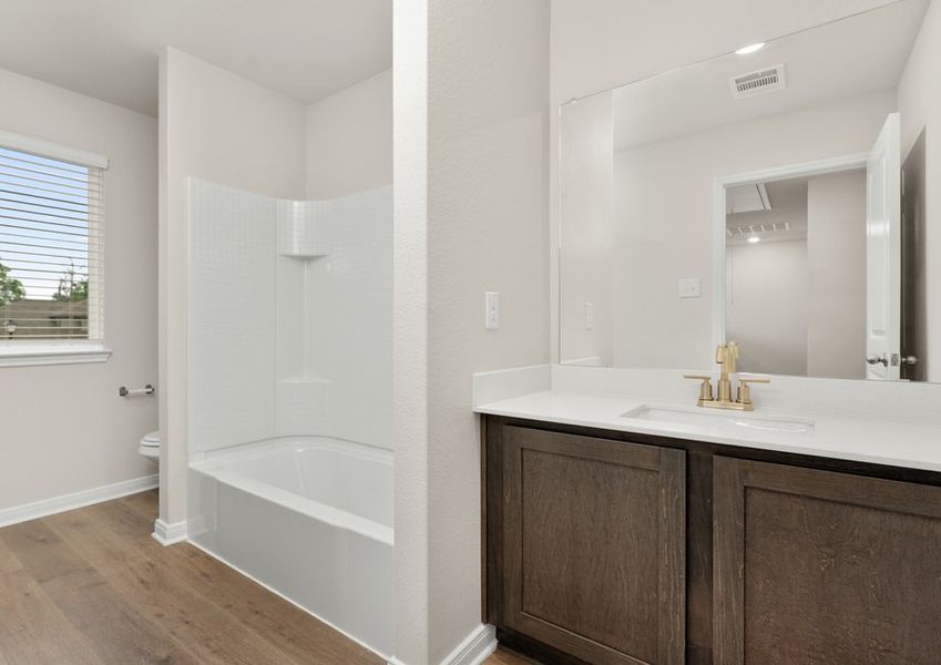 The secondary bathroom of the Cypress has a large vanity and shower-tub combo. The secondary bathroom of the Cypress has a large vanity and shower-tub combo.