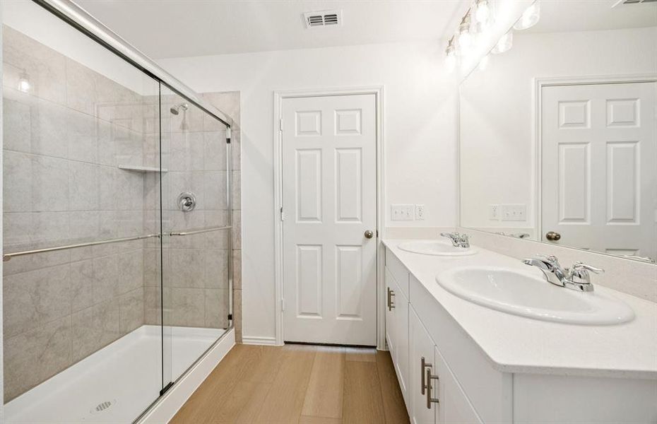 Modern owner's bath with dual vanities and a spacious shower Modern owner's bath with dual vanities and a spacious shower