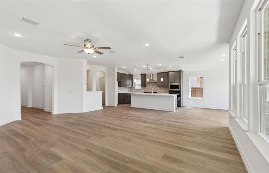 Open concept gathering room creating a spacious and inviting atmosphere *Real home pictured Open concept gathering room creating a spacious and inviting atmosphere *Real home pictured