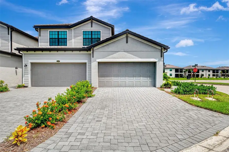 Front exterior of a new home in Legends Cove, Bradenton, FL, highlighting curb appeal (Image 2). Front exterior of a new home in Legends Cove, Bradenton, FL, highlighting curb appeal (Image 2).