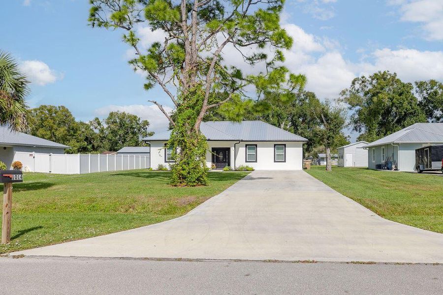 Front exterior of a new home in , Okeechobee, FL, highlighting curb appeal (Image 1).