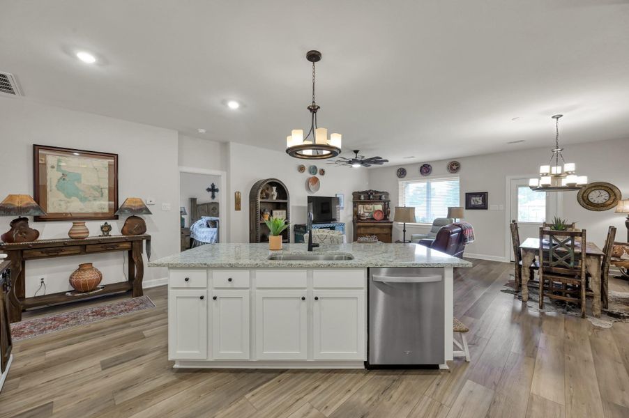 Expansive open-concept design centers around a large granite island, creating a natural gathering space while seamlessly connecting the kitchen, dining area, and family room for effortless entertaining and everyday living. Expansive open-concept design centers around a large granite island, creating a natural gathering space while seamlessly connecting the kitchen, dining area, and family room for effortless entertaining and everyday living.