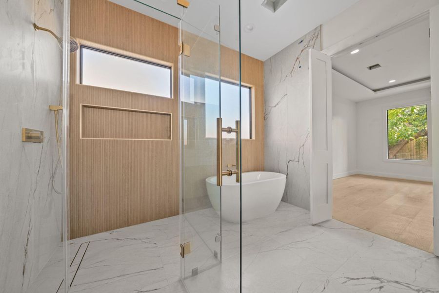 This stunning bathroom reflects highlights detailed craftsmanship and throughout layout, with a seamless blend of materials and textures. Oversized glass-enclosed shower designed with beautiful lines and contemporary finishes creating a spa-inspired experience.