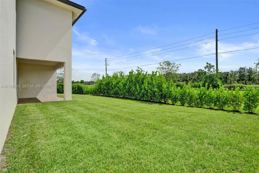Expansive green lawn with hedges