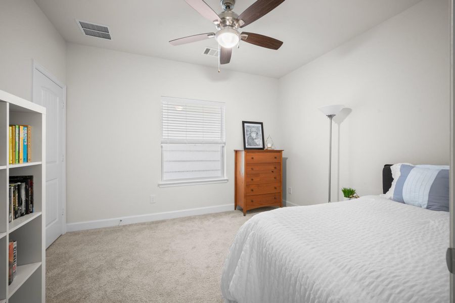 The second second-floor secondary bedroom is well-proportioned with plush carpet, a ceiling fan, and a closet — a comfortable, quiet room that works for guests, kids, or whoever needs their own space. The second second-floor secondary bedroom is well-proportioned with plush carpet, a ceiling fan, and a closet — a comfortable, quiet room that works for guests, kids, or whoever needs their own space.