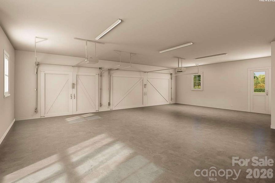 This oversized three-car garage features carriage-style doors, durable concrete flooring, multiple windows for natural light, modern openers, and a convenient side entry. This oversized three-car garage features carriage-style doors, durable concrete flooring, multiple windows for natural light, modern openers, and a convenient side entry.