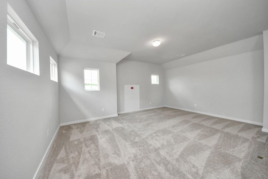 Come upstairs and enjoy a day of leisure in this fabulous game room! This is the perfect hangout spot or adult game room! Features plush carpet, high ceilings, custom paint and windows for plenty of natural light. Come upstairs and enjoy a day of leisure in this fabulous game room! This is the perfect hangout spot or adult game room! Features plush carpet, high ceilings, custom paint and windows for plenty of natural light.