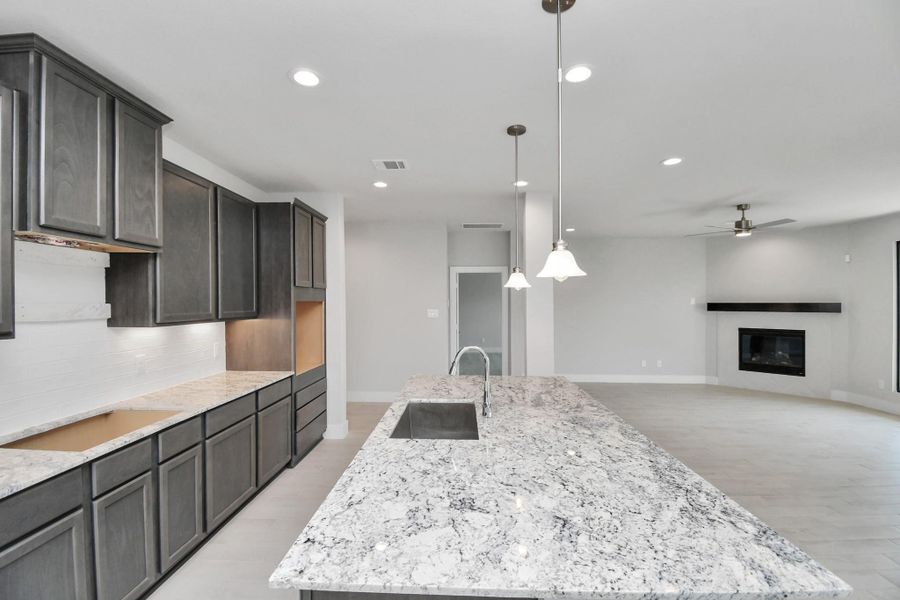 This kitchen is by far any chef’s dream! This spacious kitchen features high ceilings, stained wood cabinets, granite countertop, SS appliances, modern tile backsplash, recessed lighting, extended counter space, granite kitchen island with double sink, and space for breakfast bar, and a walk-in pantry all overlooking your huge family room. This kitchen is by far any chef’s dream! This spacious kitchen features high ceilings, stained wood cabinets, granite countertop, SS appliances, modern tile backsplash, recessed lighting, extended counter space, granite kitchen island with double sink, and space for breakfast bar, and a walk-in pantry all overlooking your huge family room.