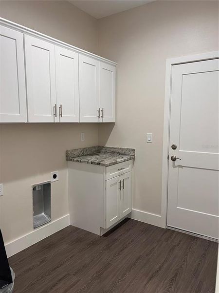 inside laundry with cabinets and granite countertop inside laundry with cabinets and granite countertop