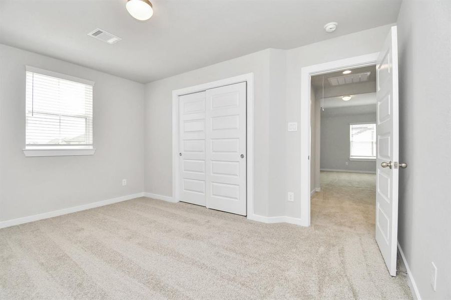 Step into this inviting bedroom retreat, boasting generously sized secondary bedrooms, plush carpeting underfoot, and ample natural light flooding through the large windows. With spacious closets to accommodate all your storage needs, this bedroom offers comfort and functionality in equal measure.