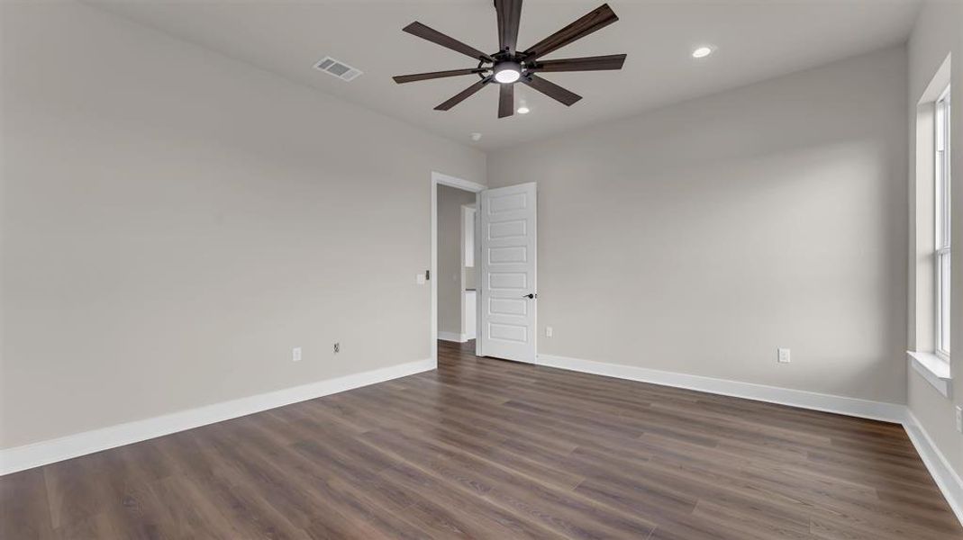 Rich wood-look flooring and tall baseboards ground this versatile interior room. Rich wood-look flooring and tall baseboards ground this versatile interior room.