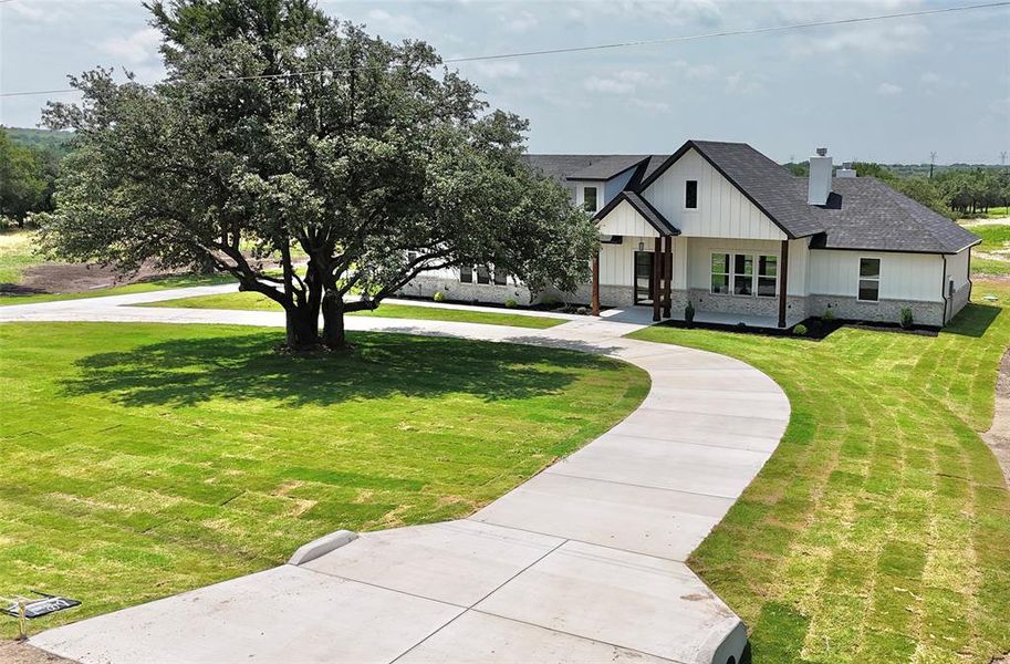 Front exterior of a new home in , Weatherford, TX, highlighting curb appeal (Image 34).