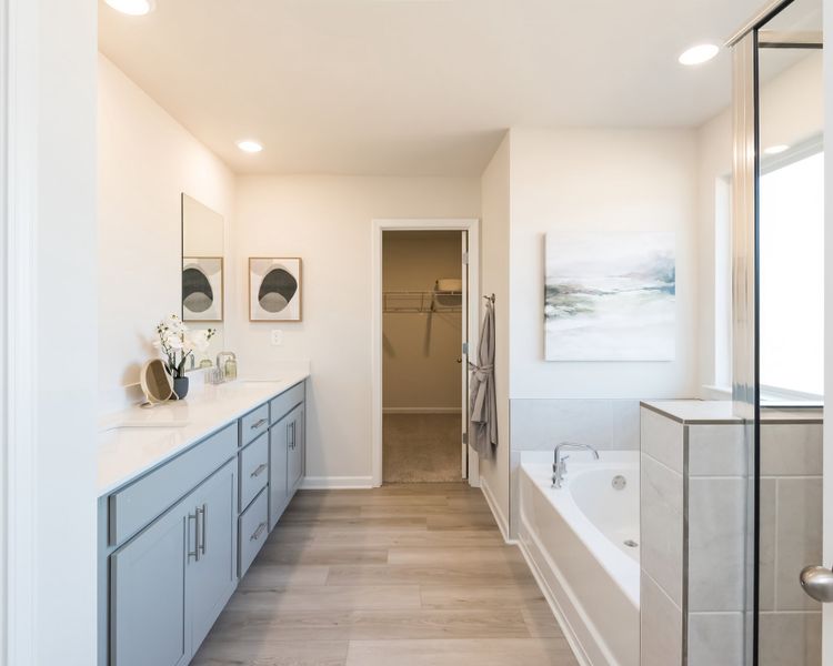 The private suite boasts a walk-in shower and dual-vanity sinks.