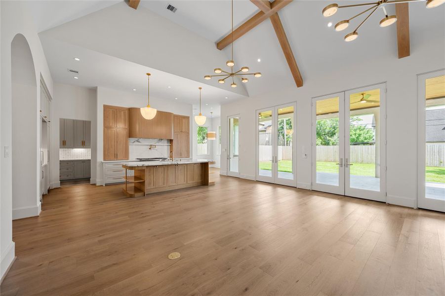 A second view of the living room shows the kitchen and the breakfast room and butler's pantry directly off the kitchen.