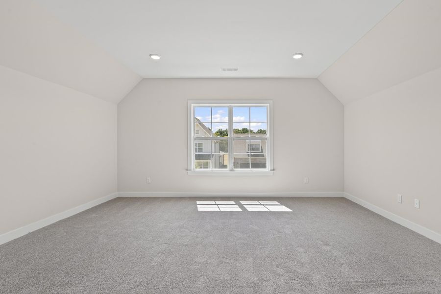 Bonus room featuring light colored carpet, vaulted ceiling, and recessed lighting Bonus room featuring light colored carpet, vaulted ceiling, and recessed lighting