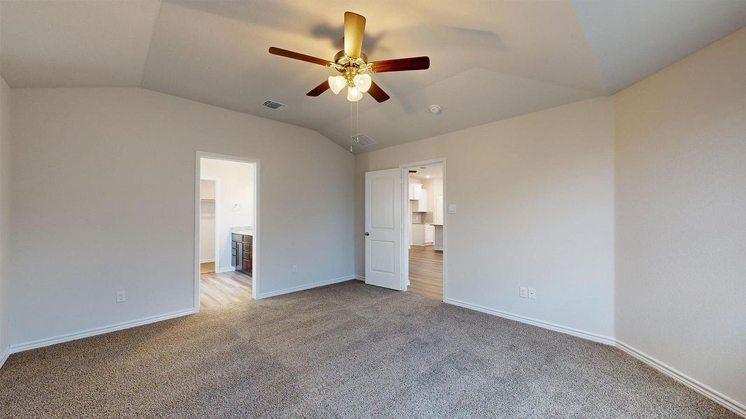 Unfurnished bedroom featuring carpet flooring, lofted ceiling, and ceiling fan Unfurnished bedroom featuring carpet flooring, lofted ceiling, and ceiling fan