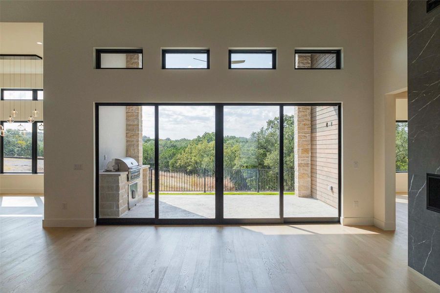 Doorway featuring wood finished floors and a high ceiling