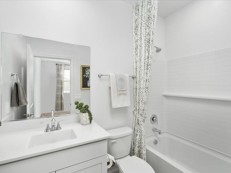The bathroom located in bedroom 4 makes the room an ideal guest suite or office.