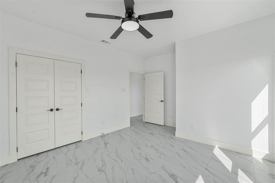 Unfurnished bedroom featuring a closet and ceiling fan