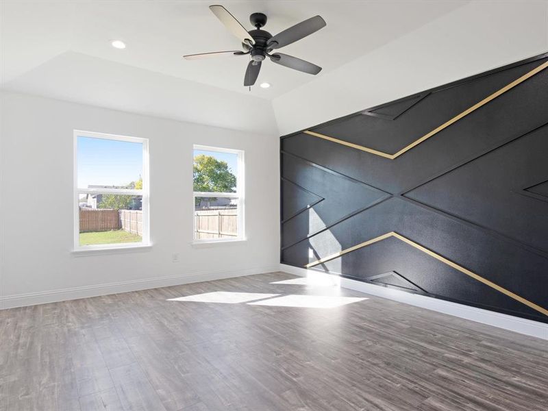 Unfurnished room featuring wood-type flooring and ceiling fan