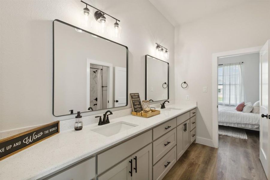 Double vanity with white solid surface countertops and integrated sinks