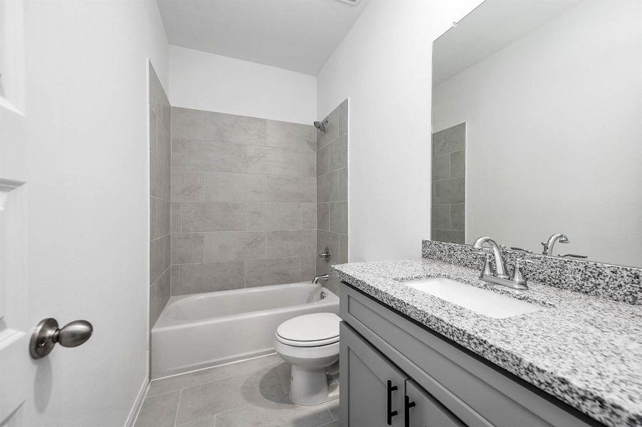 Secondary bathroom, featuring modern vanity finishes and a tub/shower combo. Secondary bathroom, featuring modern vanity finishes and a tub/shower combo.