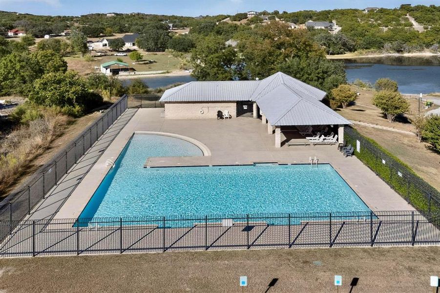 Community pool with a patio and a water view